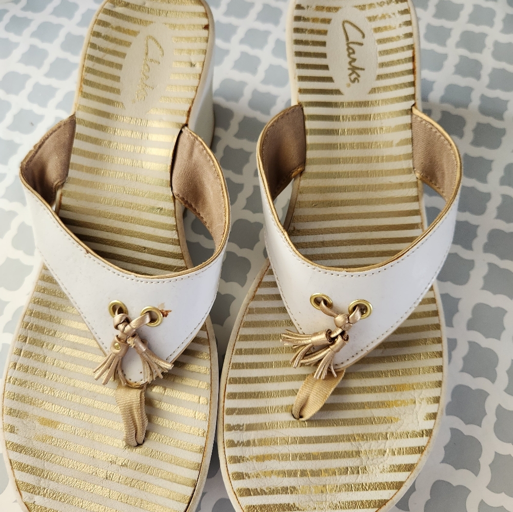 Clark's white/gold tasseled platform sandals.